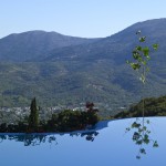 Infinity swimming pool with panoramic view to the village Avdou at Country Hotel Velani in Greece crete.