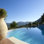 The swimming pool of Country Hotel Velani in Greece is located in lovely nature.